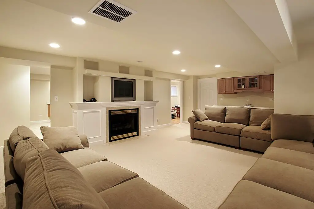 Spacious finished basement with sofas and TV.