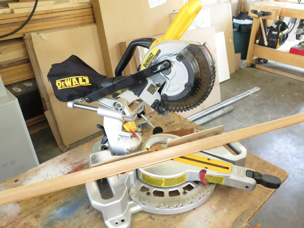 DeWalt miter saw on workbench in workshop.