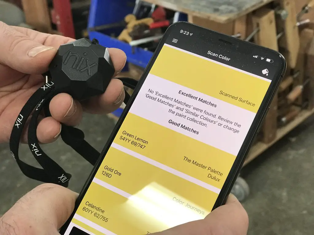 Person using Nix device with colour analysis app.