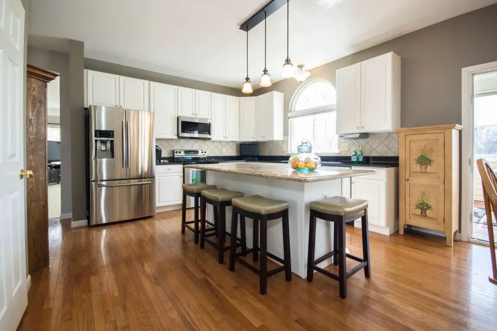 Modern kitchen with island and stainless steel appliances.