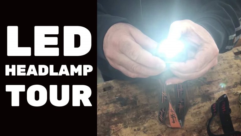 Person holding bright LED headlamp, inspecting brightness.