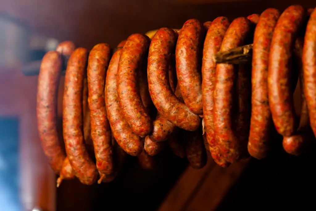 Hanging smoked sausages in a row