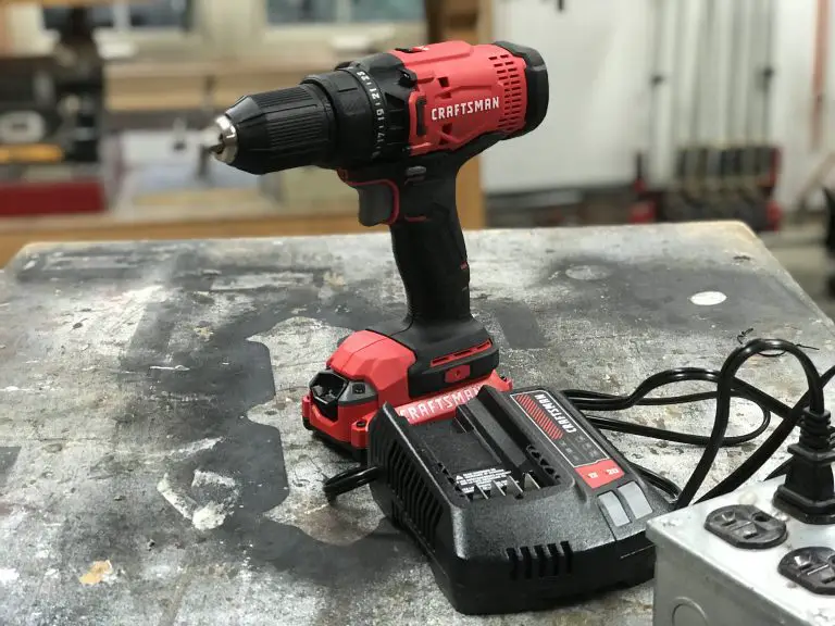Cordless drill on workshop table with charger