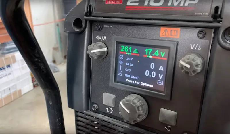 Digital MIG welder display with settings and controls.