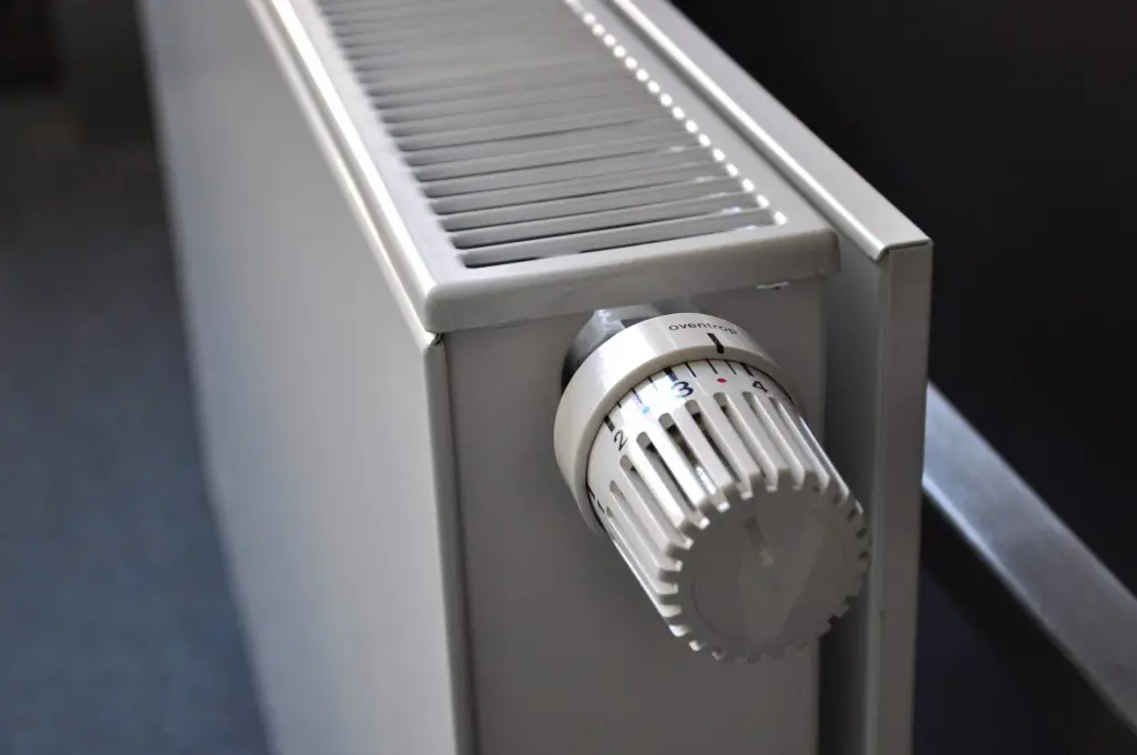 White radiator with a thermostat knob