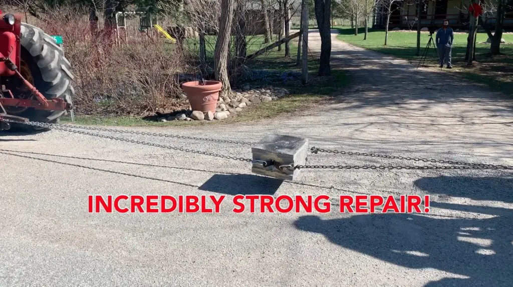 Tractor pulling heavy load with strong chains.