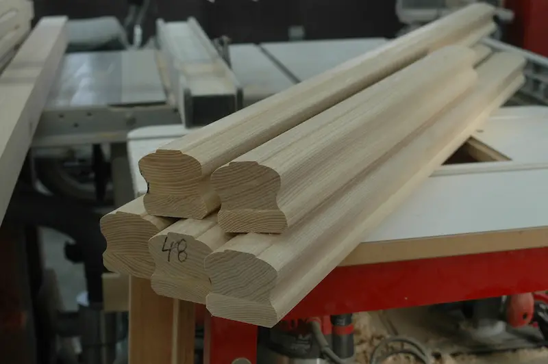 A run of ash hand rails, ready for prefinishing and installation as part of a stair railing.