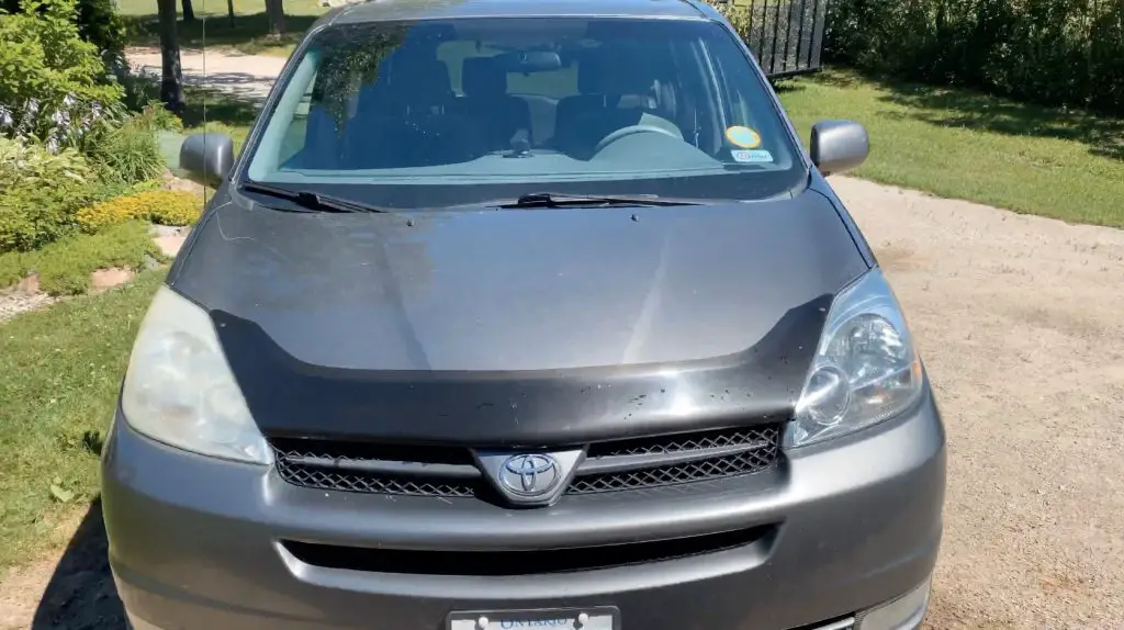 Grey Toyota car parked on driveway.