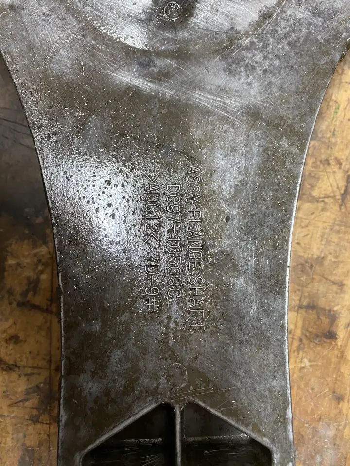 Close-up of embossed metal component with text details.