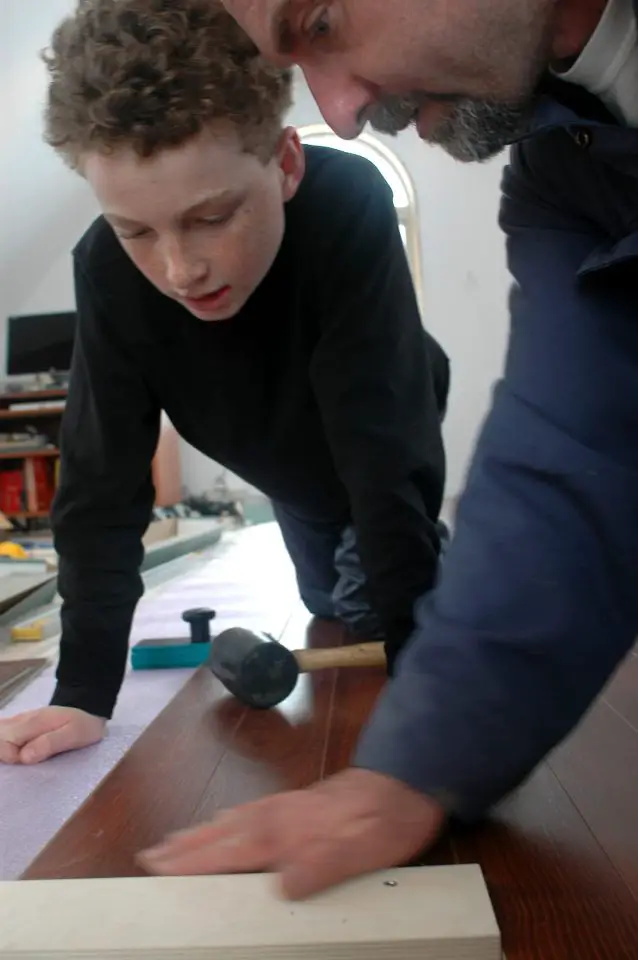Here I am installing some laminate flooring with Joseph, one of our brood of kids. Get kids involved when they’re young and they’re likely to remember and use the skills you taught them.