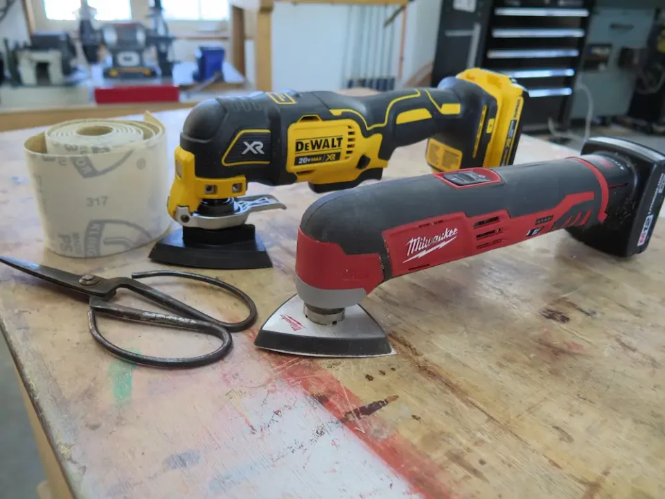 The roll of Velcro-backed sandpaper (background) can be used with any kind of detail sander. Simply place the pad of the sander on the paper, then trim around the outside with scissors.