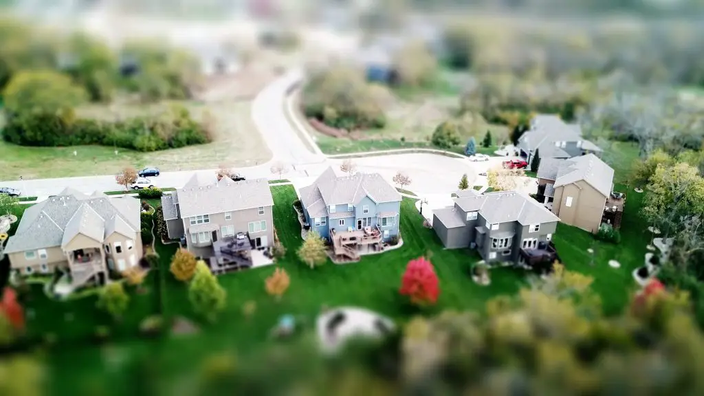 Aerial view of suburban houses and greenery.