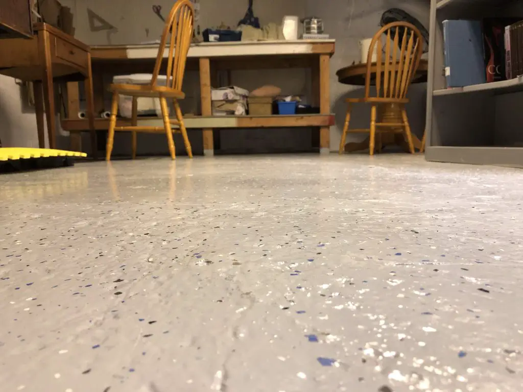 Epoxy floor in workshop with chairs and tables.