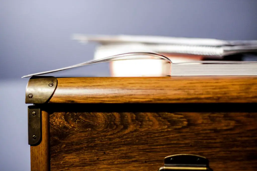Open book on wooden desk close-up.