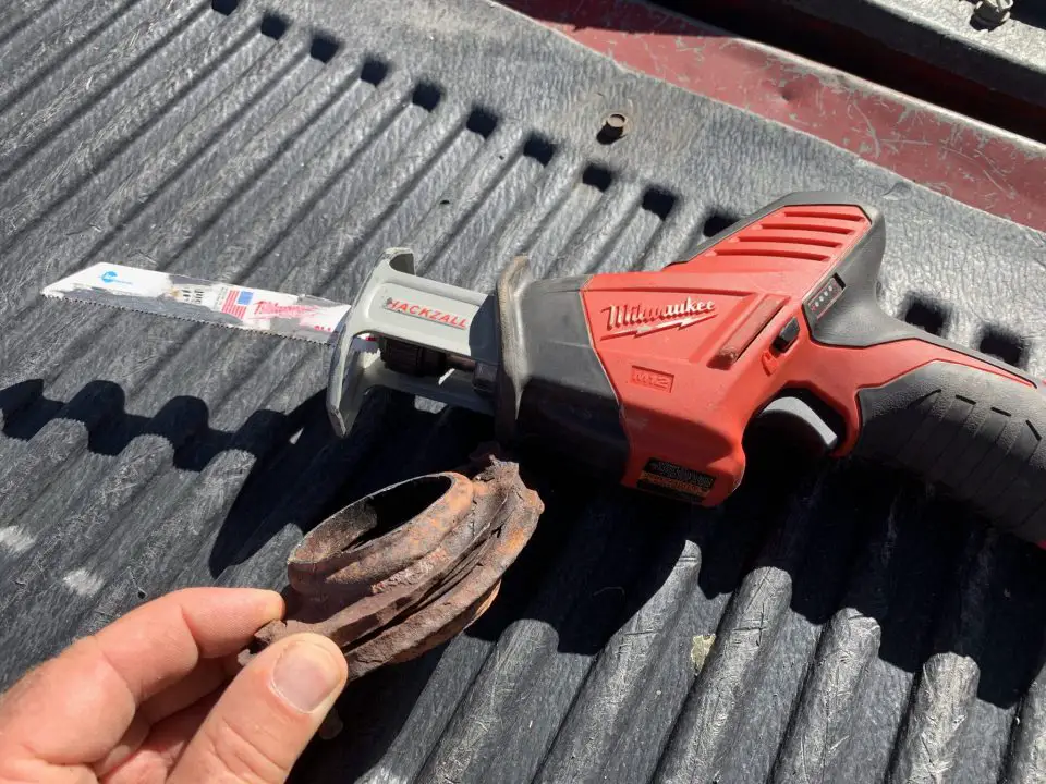 The compact 12 volt recip saw you see here is perfect for getting into tight spaces while doing auto repairs. Here you can see an exhaust pipe flange I cut out of an otherwise sound exhaust system before adding new pipe to complete the repair.