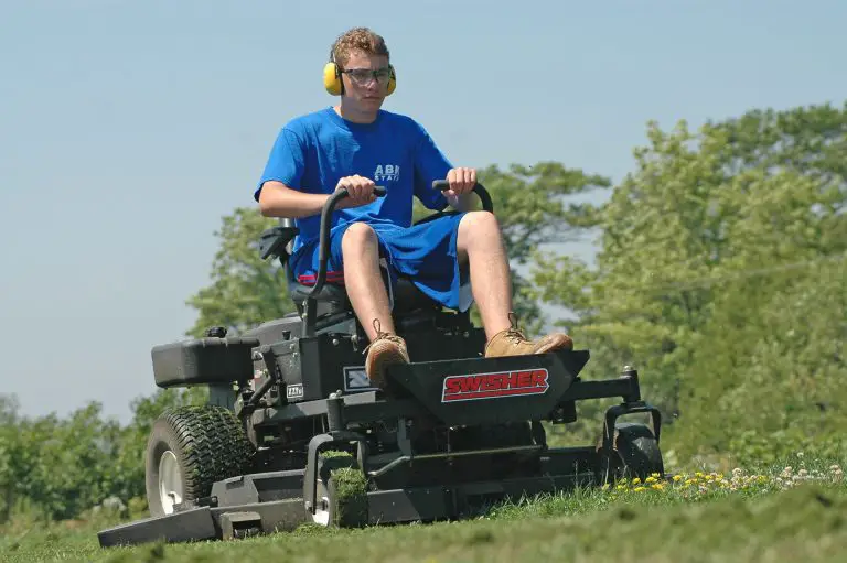 Man operating a riding lawn mower outdoors.