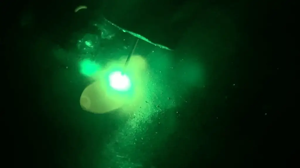 Green laser melting material in the dark.