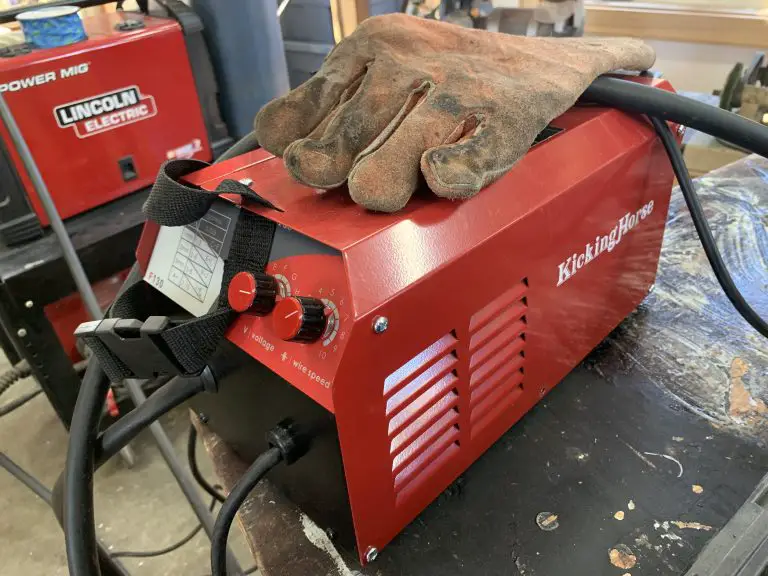 Red KickingHorse welder with gloves on top.