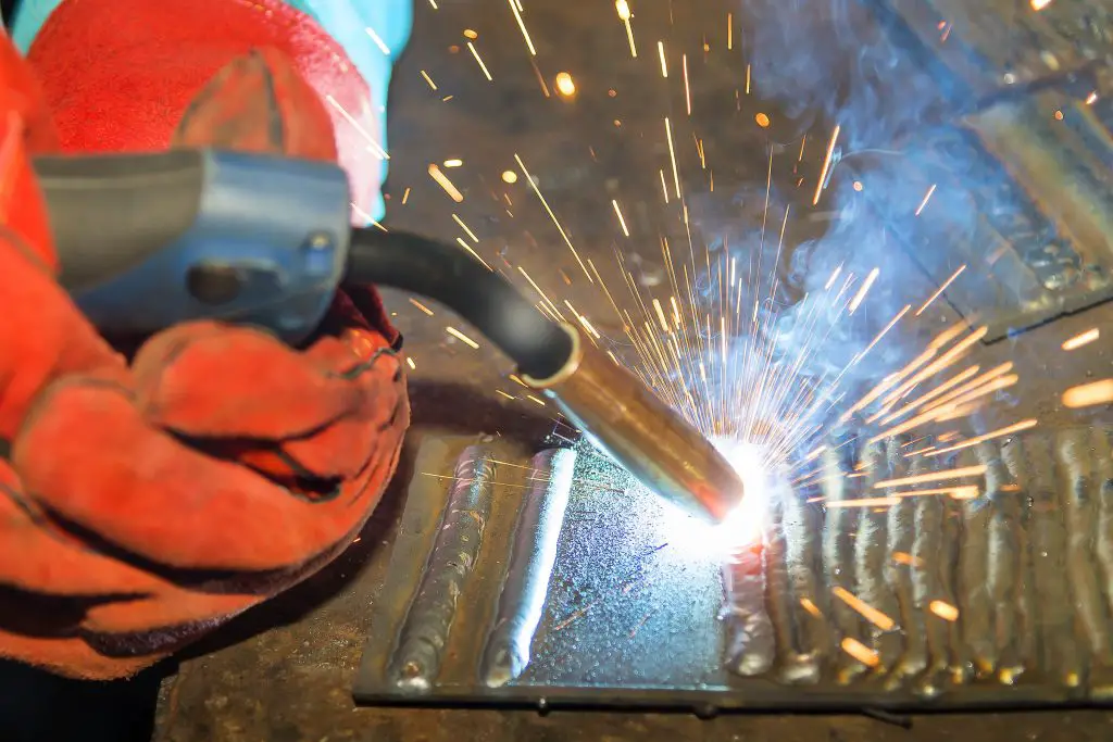 Close-up of welding sparks on metal surface.