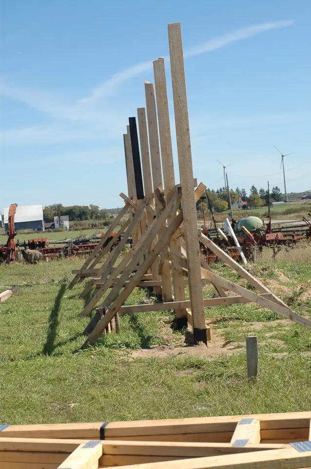 This is why they’re called “pole barns”. Pole lined up and plumbed with braces are the essential starting point for construction.