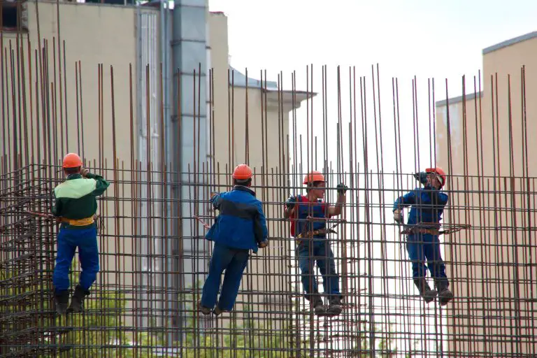 Construction workers on rebar framework.