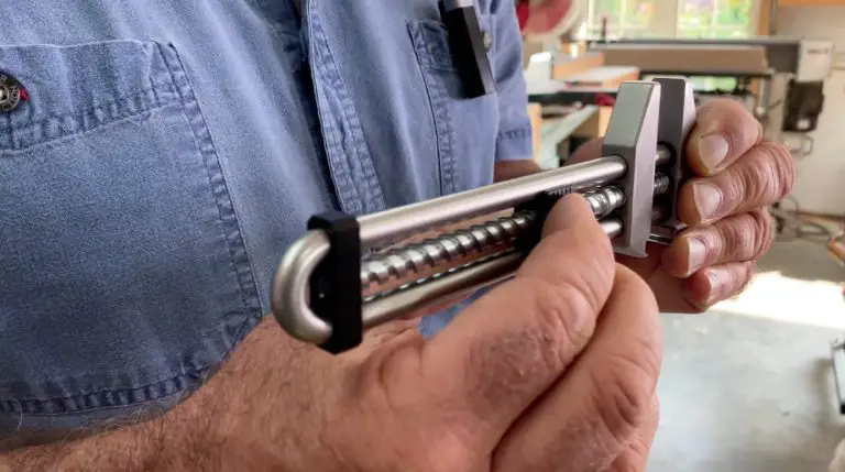 Man holding woodworking tool in workshop.