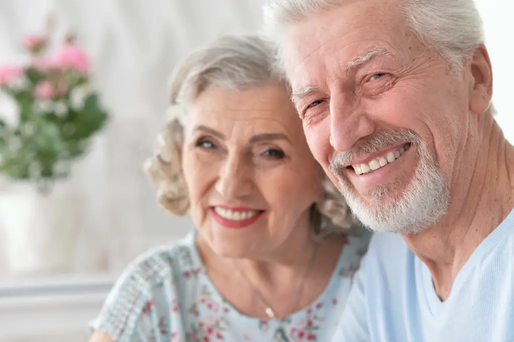 Smiling elderly couple enjoying time together indoors.
