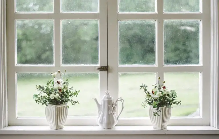 Vases and teapot on window ledge.