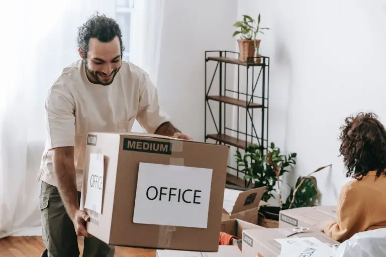 Man moving office box in living room.