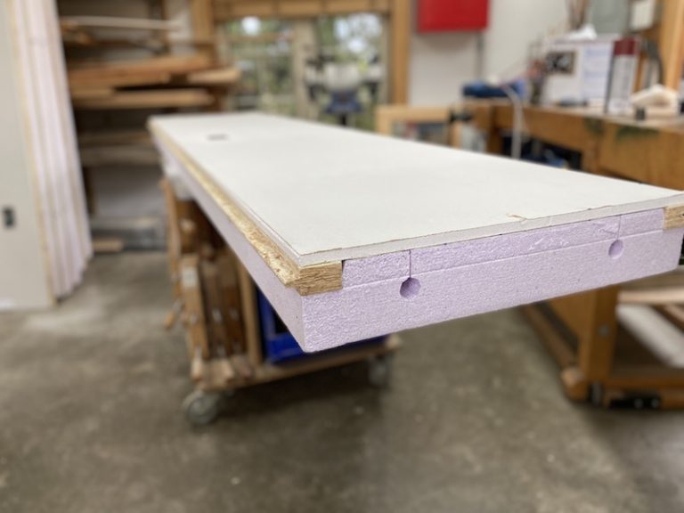 Insulated door panel on workshop table.