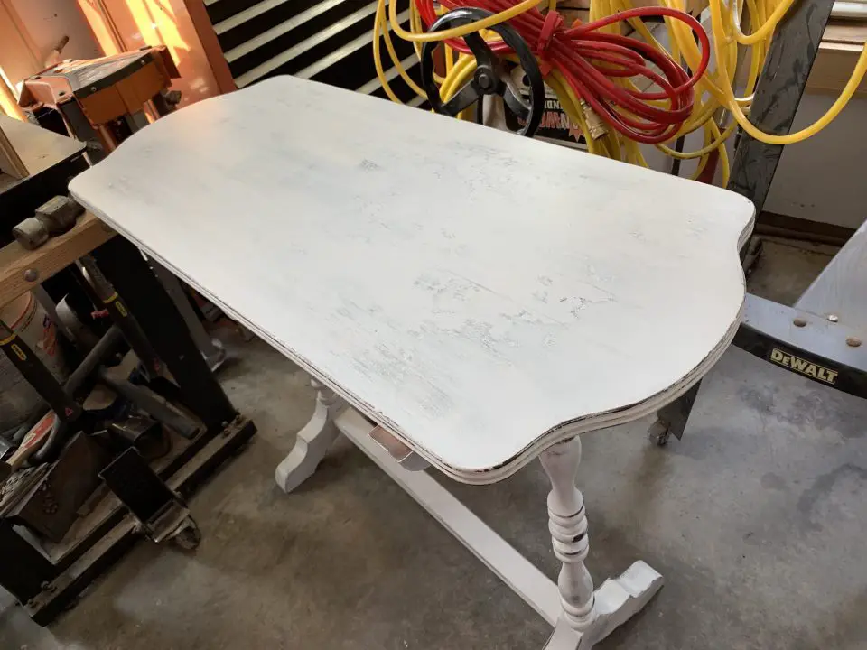 Chalked paint was applied to the failing finish of this antique table. Intentionally rubbing through the paint after it was dry created the distressed look you see here.