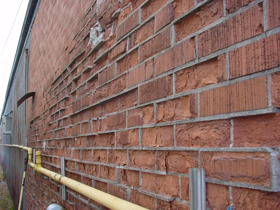 This is a classic example of brick with a manufacturing defect. This opinion is verified by the fact that some brick on this wall is fine, while other bricks are deteriorating right next door.