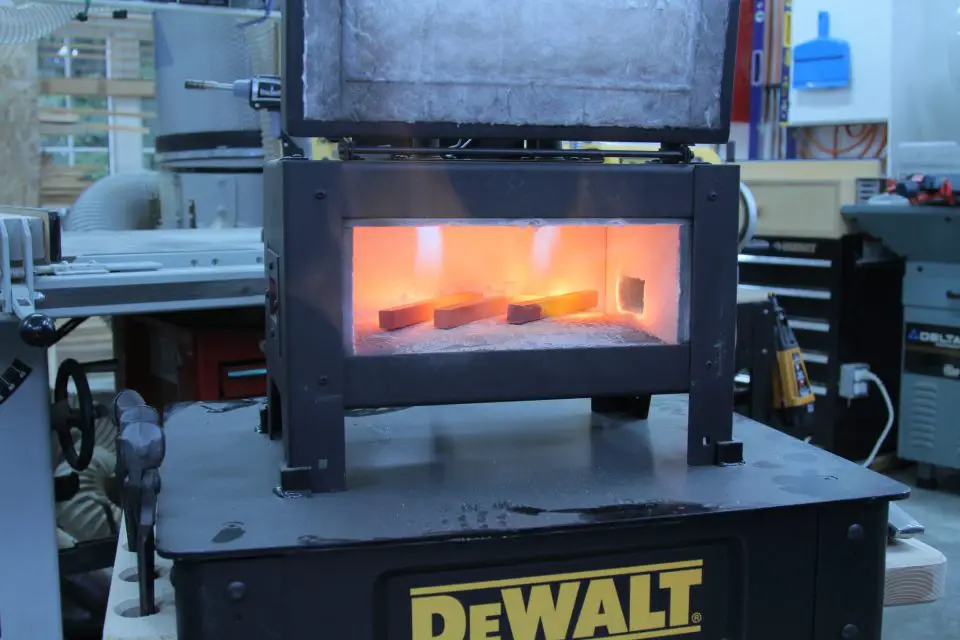 This propane forge takes less than 10 minutes to heat cold billets of steel to red hot. The forge is bolted to the rolling steel cart supporting it.