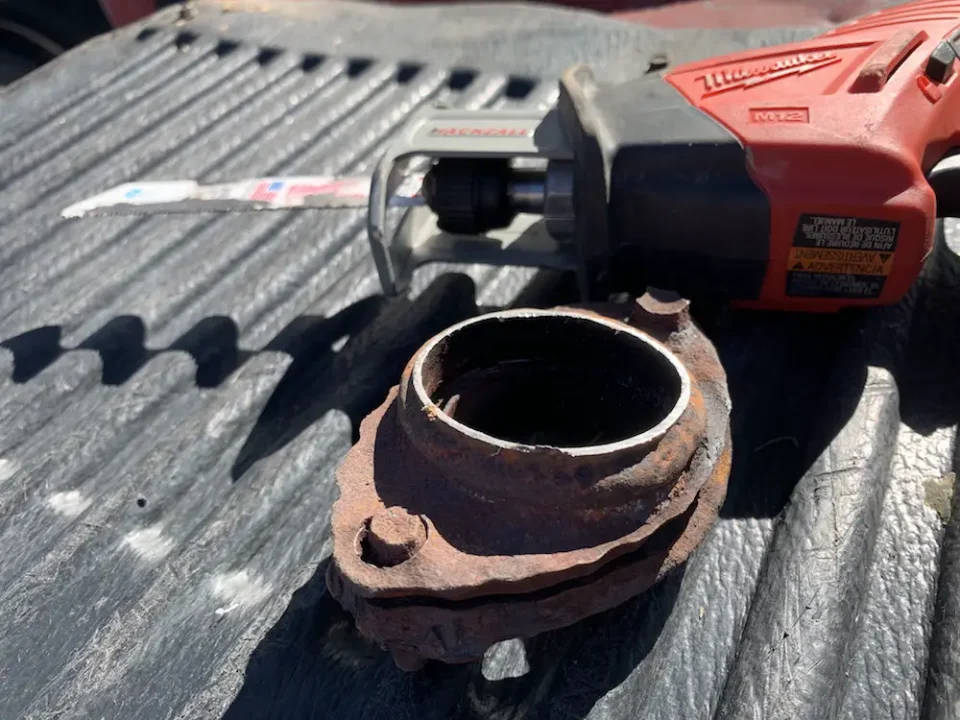 I cut this bad exhaust flange out of an automotive exhaust system using the 12 volt recip saw in the background