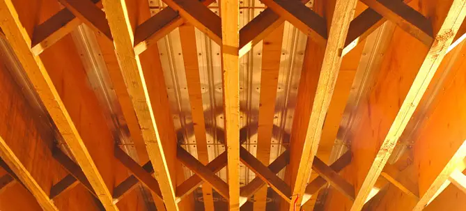 The plastic pipes on the underside of this floor fit into aluminum channels that distribute heat more evenly to the wood floor above. Warm floors make rooms seem more comfortable at lower air temperatures.
