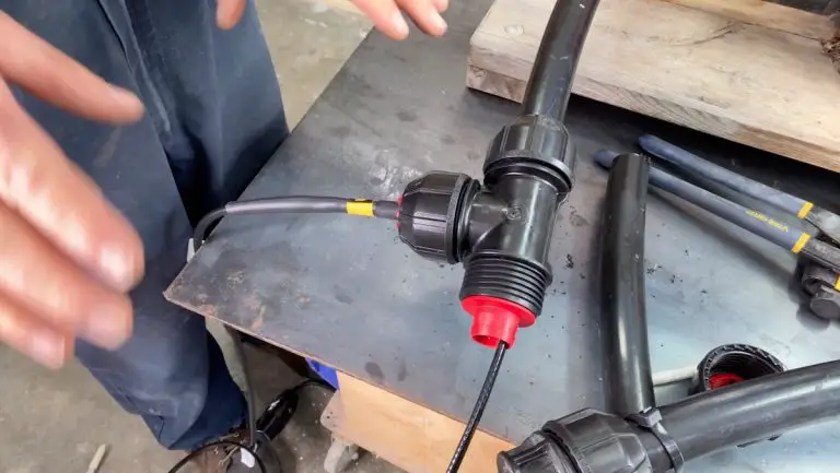 Person installing black plastic pipe connector