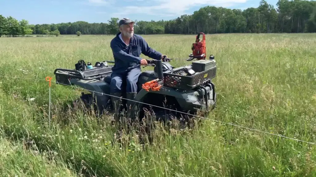 Man on ATV in grassy field