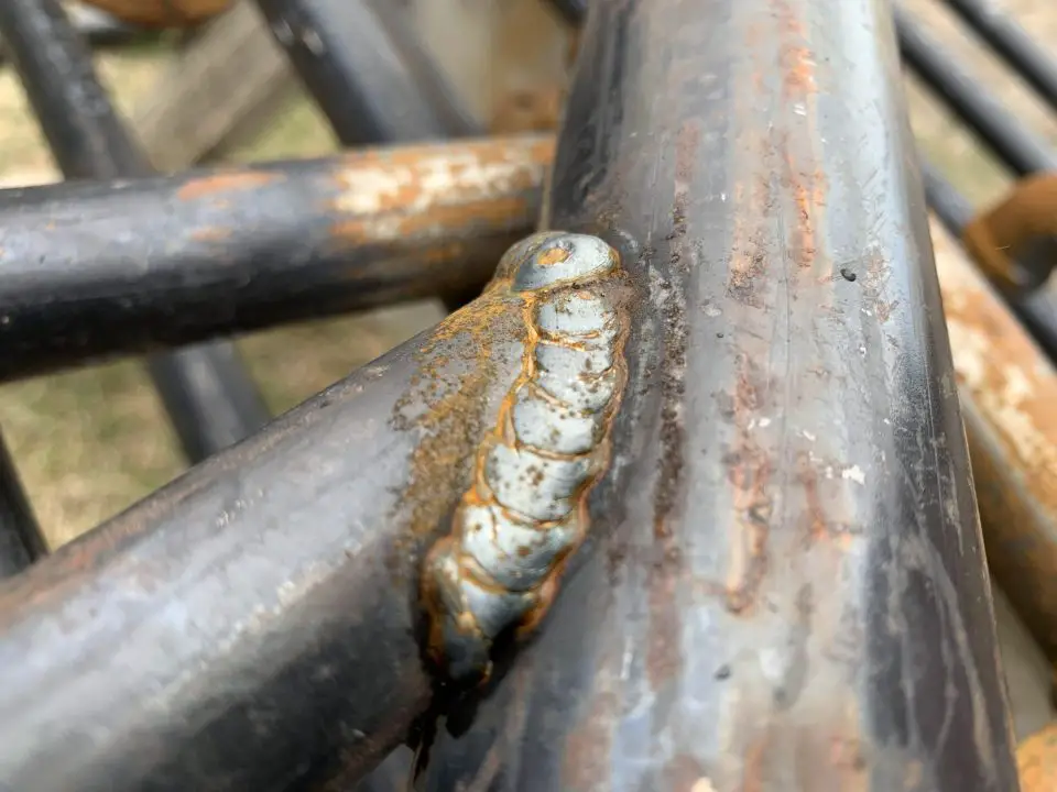 This MIG weld joining two pieces of pipe at an angle is strong because the bead has good penetration into the parent metal.