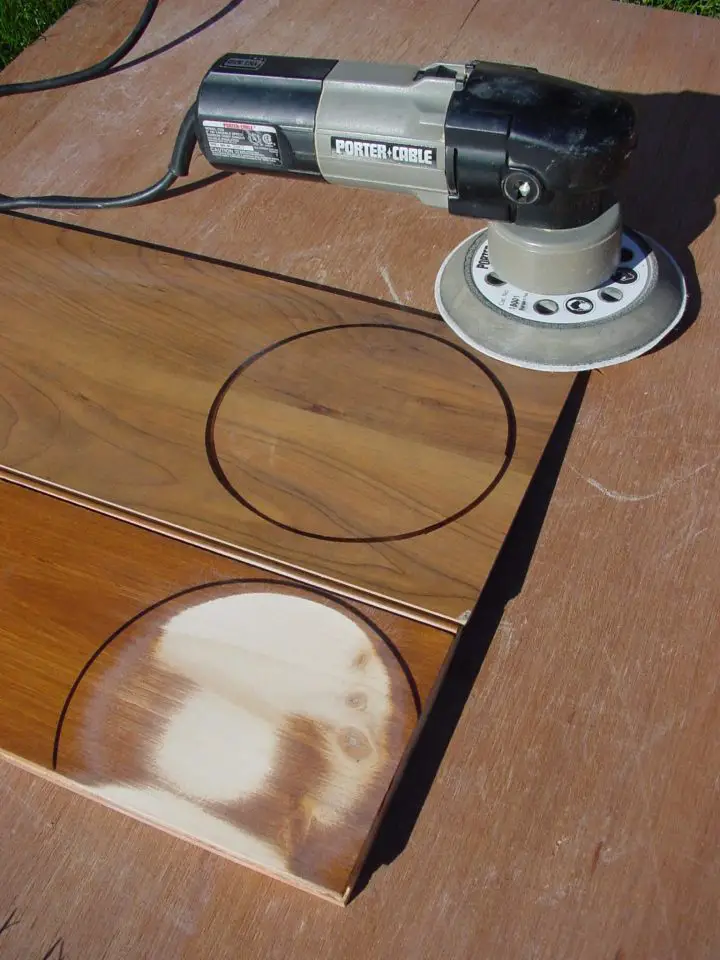 Both pieces here had a sander pressed against them for one minute. The stained and urethaned pine (bottom) shows a lot of wear, while the synthetic material above has no marks at all.