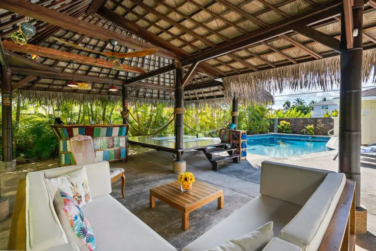 Tropical outdoor patio with bar and pool.