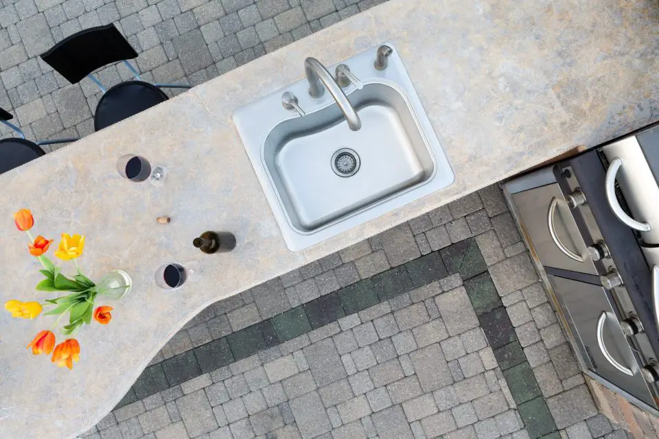 This outdoor countertop is made of concrete that’s been ground and polished to a high sheen. Concrete countertops are essential like stone counters in that they need to be polished to be attractive.