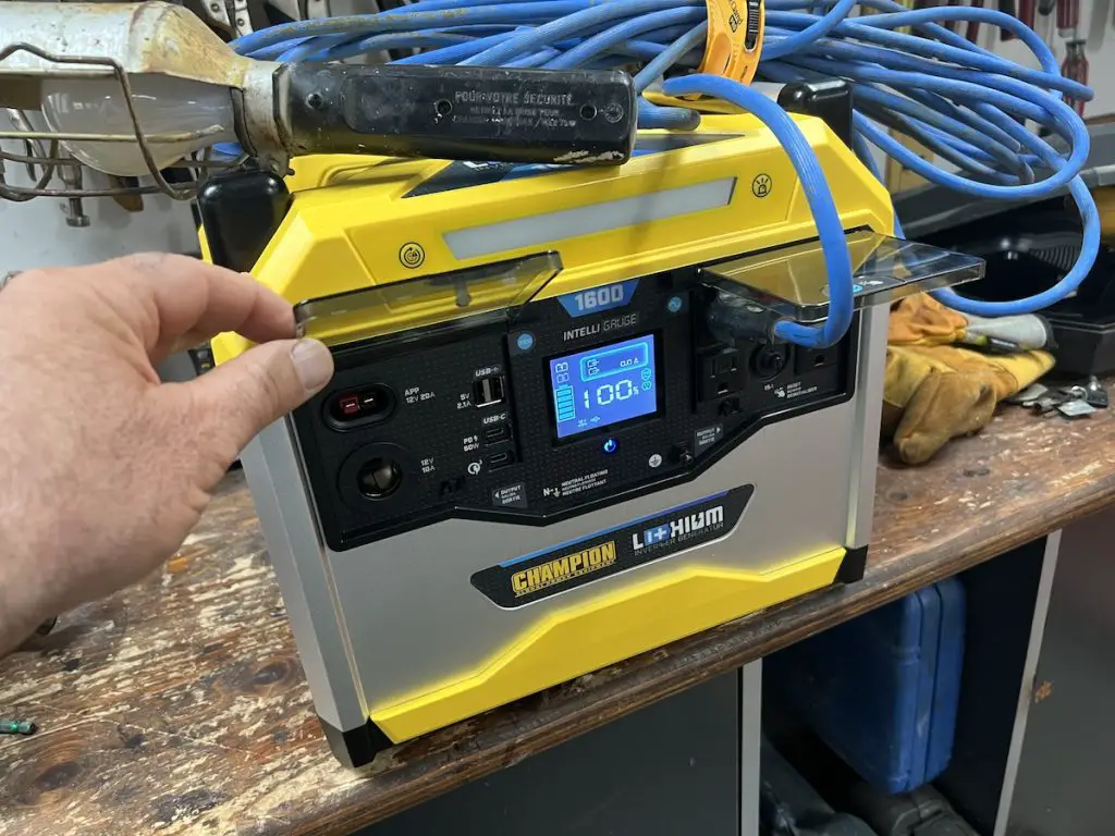 Person operating a portable power generator indoors.