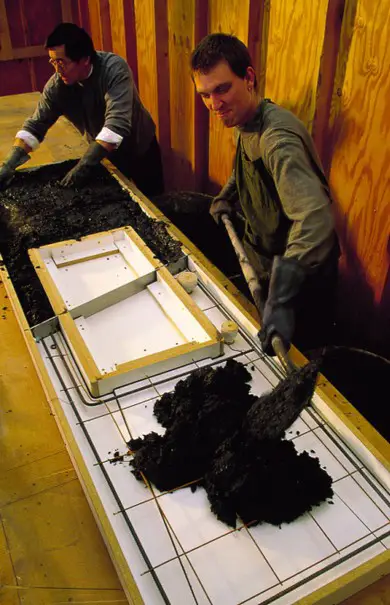 This is how a concrete countertop is formed. Very dry, custom mixtures of a mortar-like substance are placed in a form, sometimes with reinforcing elements embedded in the concrete.