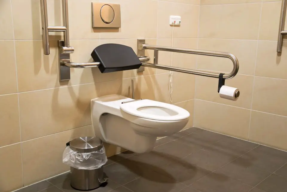 This easy-access toilet arrangement is part of a barrier-free bathroom installation. New tiling products exist today that make it easier than ever to customize a bathroom layout