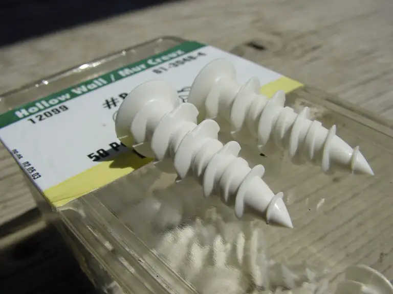 White plastic wall anchors on packaging