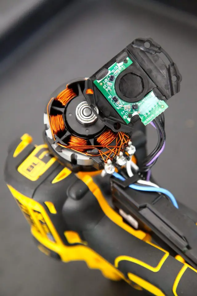 Opening up this DEWALT brushless drill shows the simpler motor of brushless power tools. The circuitry with the wires leading from it take the place of mechanical brushes and springs