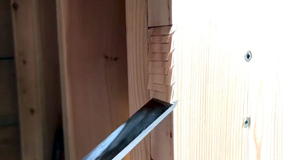 Chisel carving wooden joint in woodwork process.
