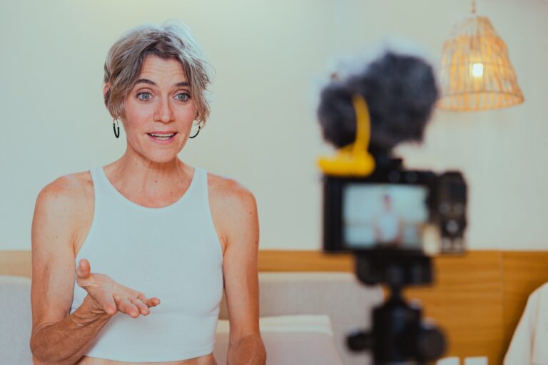 Person speaking on camera during video recording session.