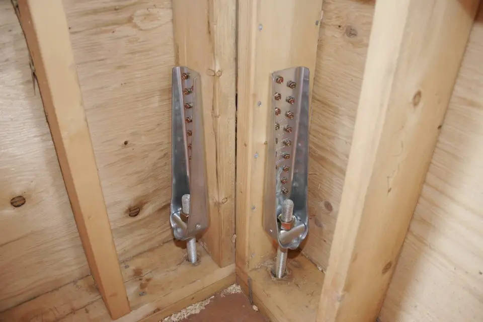 These metal brackets are secured with multiple screws each since they’re designed to hold the walls during during big winds. The threaded rod goes all the way down to the foundation and is anchored to it.