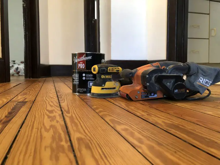 Wood floor refinishing tools beside varnish can.